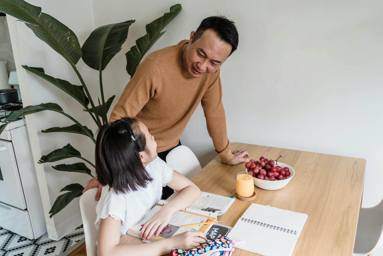 A Man Helping his Daughter with her Homework